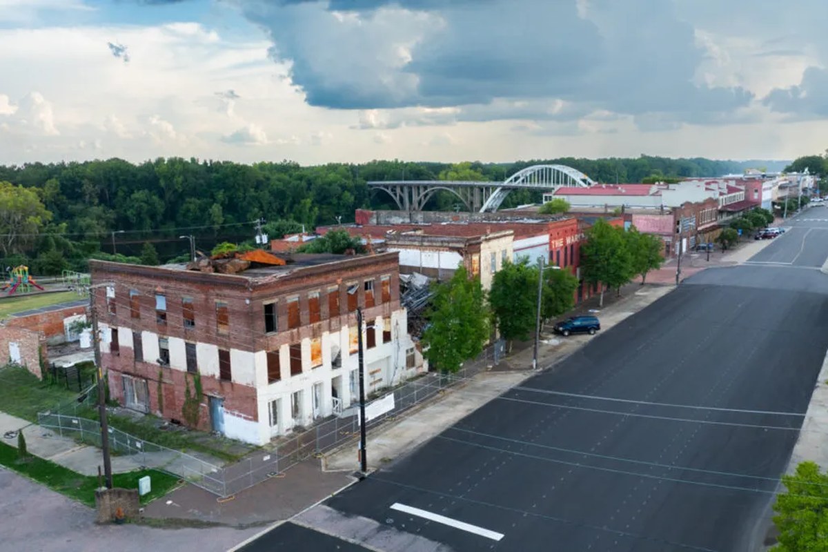 An overhead view of a historic building on the corner of a long road