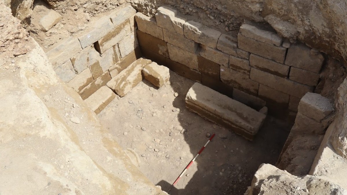 a view into a stone-lined tomb being excavated in Italy