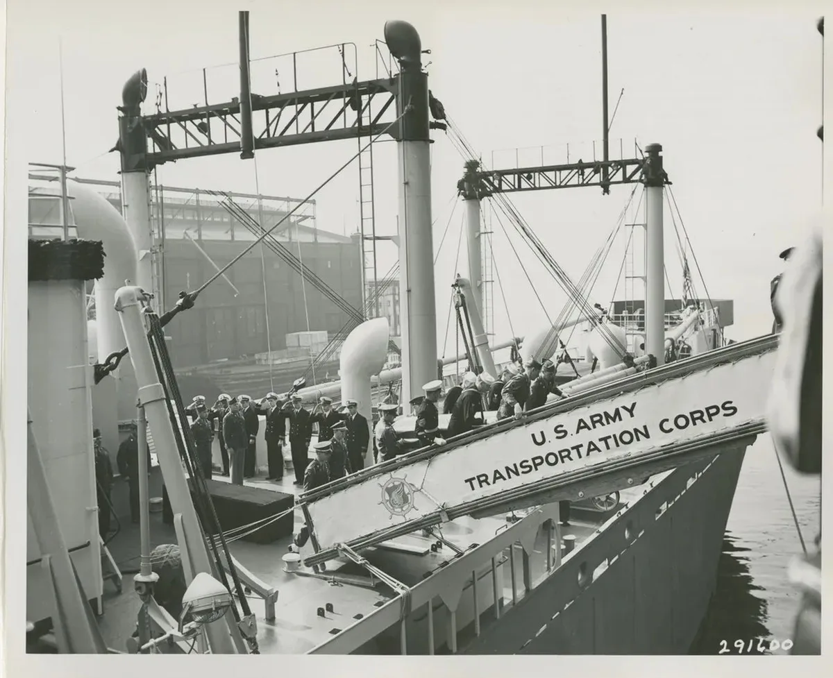Pallbearers remove a casket containing the remains of a Medal of Honor winner from the Joseph V. Connolly.